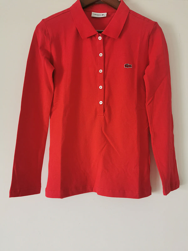 Flat lay presentation of Lacoste luxury clothing with logo-detail design