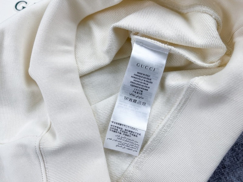Side profile of Gucci luxury clothing with signature branding
