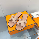 Hermès Beige Slide Sandals - Angled View