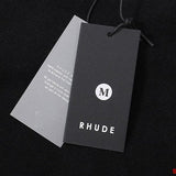 Close-up detail shot of Rhude luxury clothing with signature branding