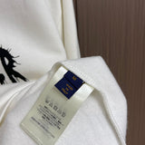 Close-up detail shot of Louis Vuitton luxury clothing with signature branding