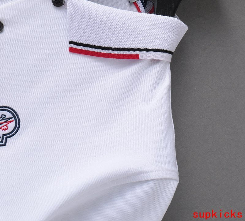 Flat lay presentation of Moncler luxury clothing with monogram-inspired silhouette