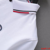 Flat lay presentation of Moncler luxury clothing with monogram-inspired silhouette