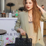 Front view of elevated modern women's handbag – women's luxury accessory