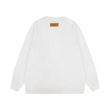 Close-up detail shot of Louis Vuitton luxury clothing with label-forward styling