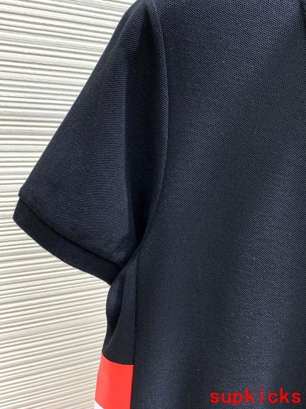 Flat lay presentation of Moncler luxury clothing with signature branding