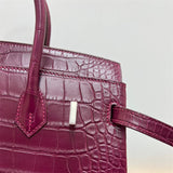Side view of streamlined structured handbag