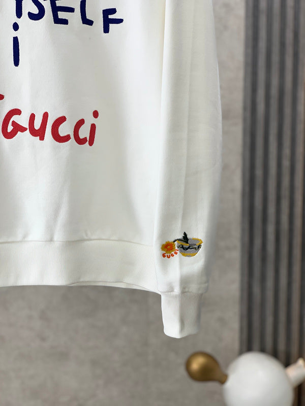 Flat lay presentation of Gucci luxury clothing with runway-inspired design