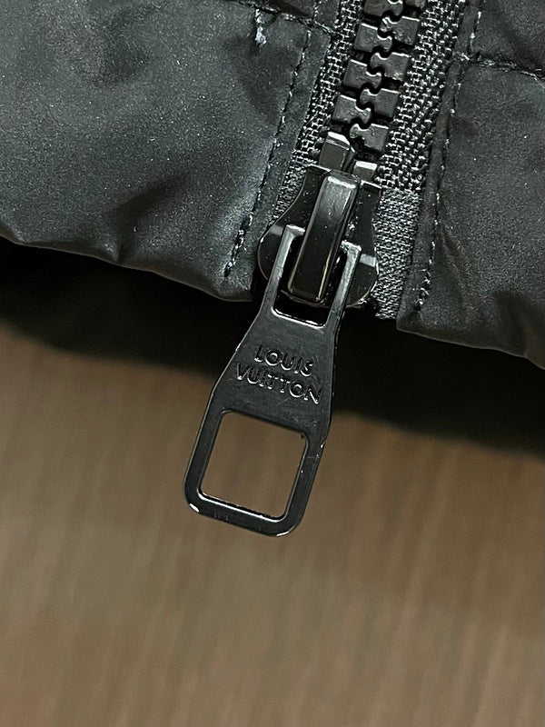 Close-up detail shot of Louis Vuitton luxury clothing with logo-detail design
