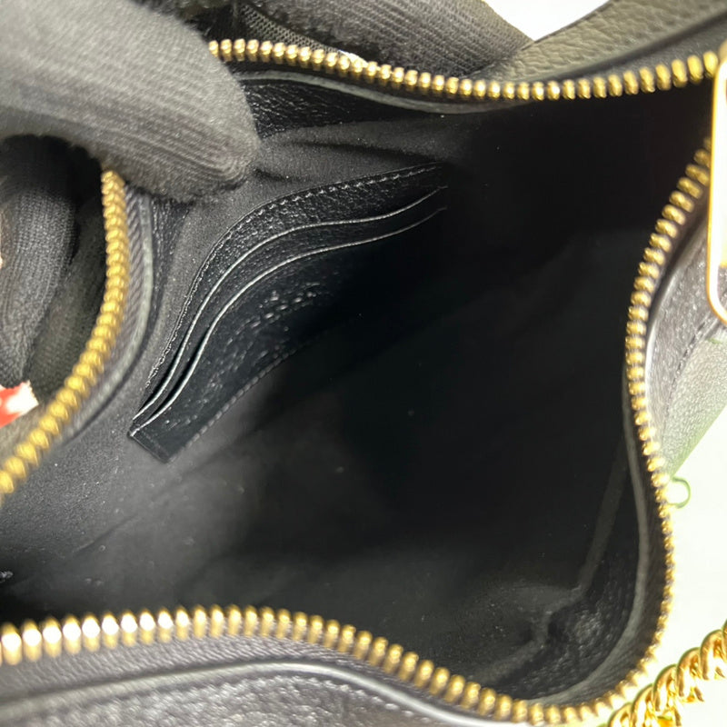 Side profile of polished elevated women's handbag – women's luxury accessory