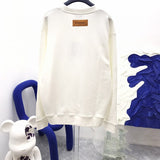 Back view of Louis Vuitton luxury clothing with label-forward styling