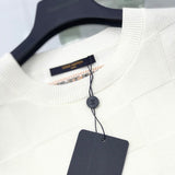 Flat lay presentation of Louis Vuitton luxury clothing with signature branding
