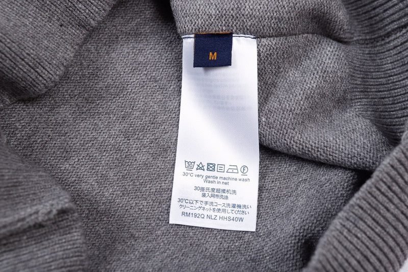 Close-up detail shot of Louis Vuitton luxury clothing with label-forward styling