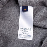 Close-up detail shot of Louis Vuitton luxury clothing with label-forward styling