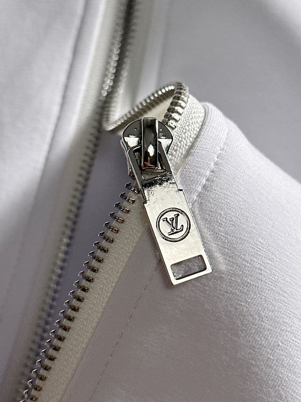 Flat lay presentation of Louis Vuitton luxury clothing with runway-inspired design