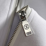 Flat lay presentation of Louis Vuitton luxury clothing with runway-inspired design