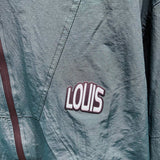 Flat lay presentation of Louis Vuitton luxury clothing with label-forward styling
