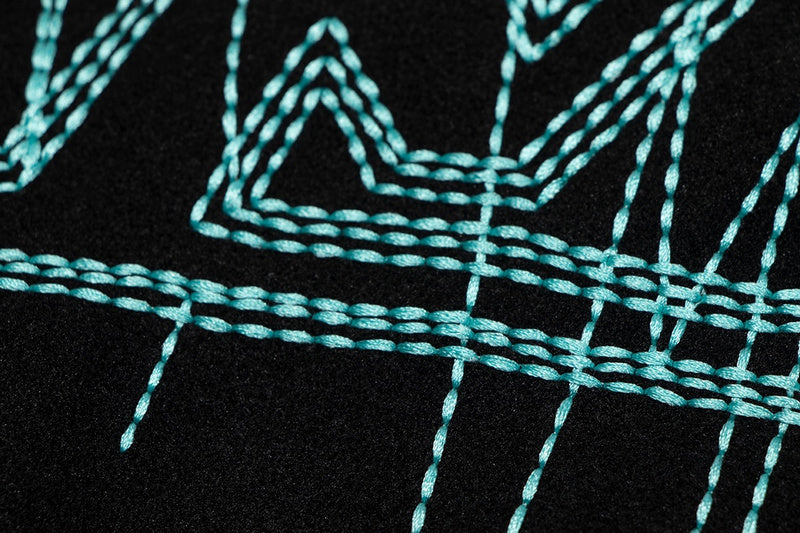 Close-up detail shot of Louis Vuitton luxury clothing with label-forward styling