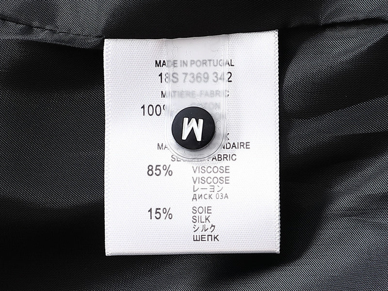Close-up detail shot of Louis Vuitton luxury clothing with signature branding
