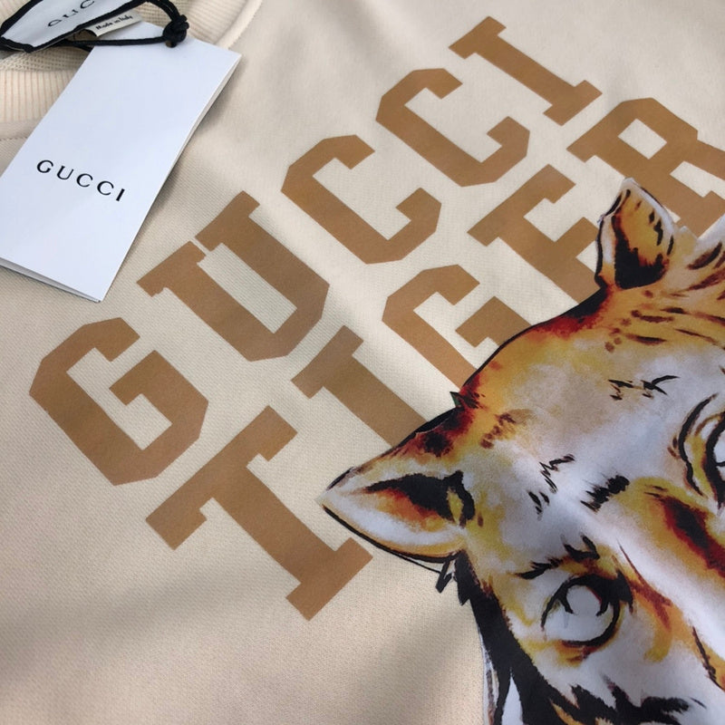 Flat lay presentation of Gucci luxury clothing with relaxed-fit cut