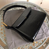 Side profile of structured refined women's handbag – women's luxury accessory