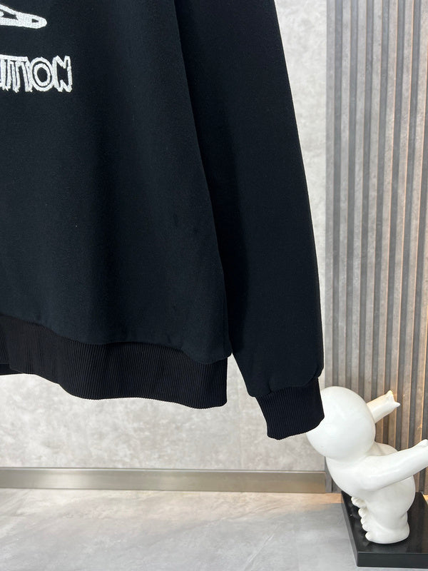 Back view of Louis Vuitton luxury clothing with label-forward styling