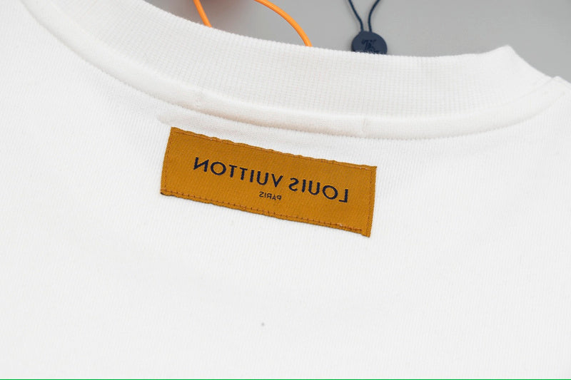 Flat lay presentation of Louis Vuitton luxury clothing with signature branding