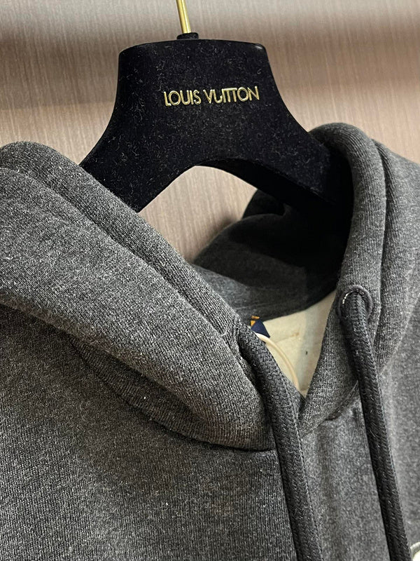 Close-up detail shot of Louis Vuitton luxury clothing with signature branding