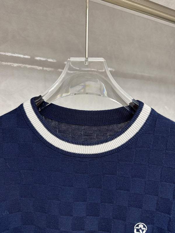Close-up detail shot of Louis Vuitton luxury clothing with signature branding