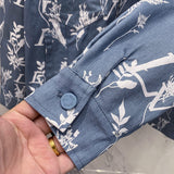 Flat lay presentation of Louis Vuitton luxury clothing with label-forward styling