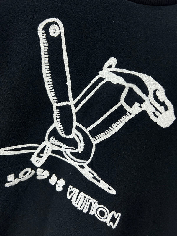Flat lay presentation of Louis Vuitton luxury clothing with label-forward styling