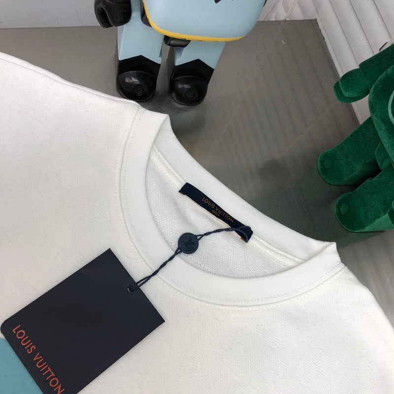Close-up detail shot of Louis Vuitton cotton t-shirt with label-forward styling