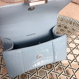Side profile of structured polished women's handbag – women's designer-style accessory