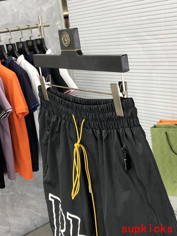 Flat lay presentation of Rhude luxury clothing with logo-detail design