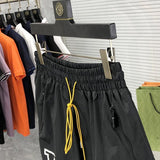Flat lay presentation of Rhude luxury clothing with logo-detail design