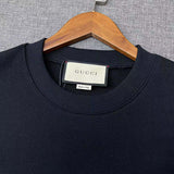 Front view of Gucci luxury clothing with signature branding