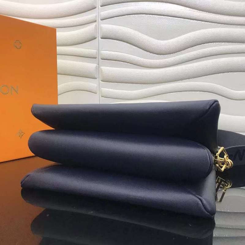 Styled lifestyle shot of structured signature women's handbag – women's luxury handbag