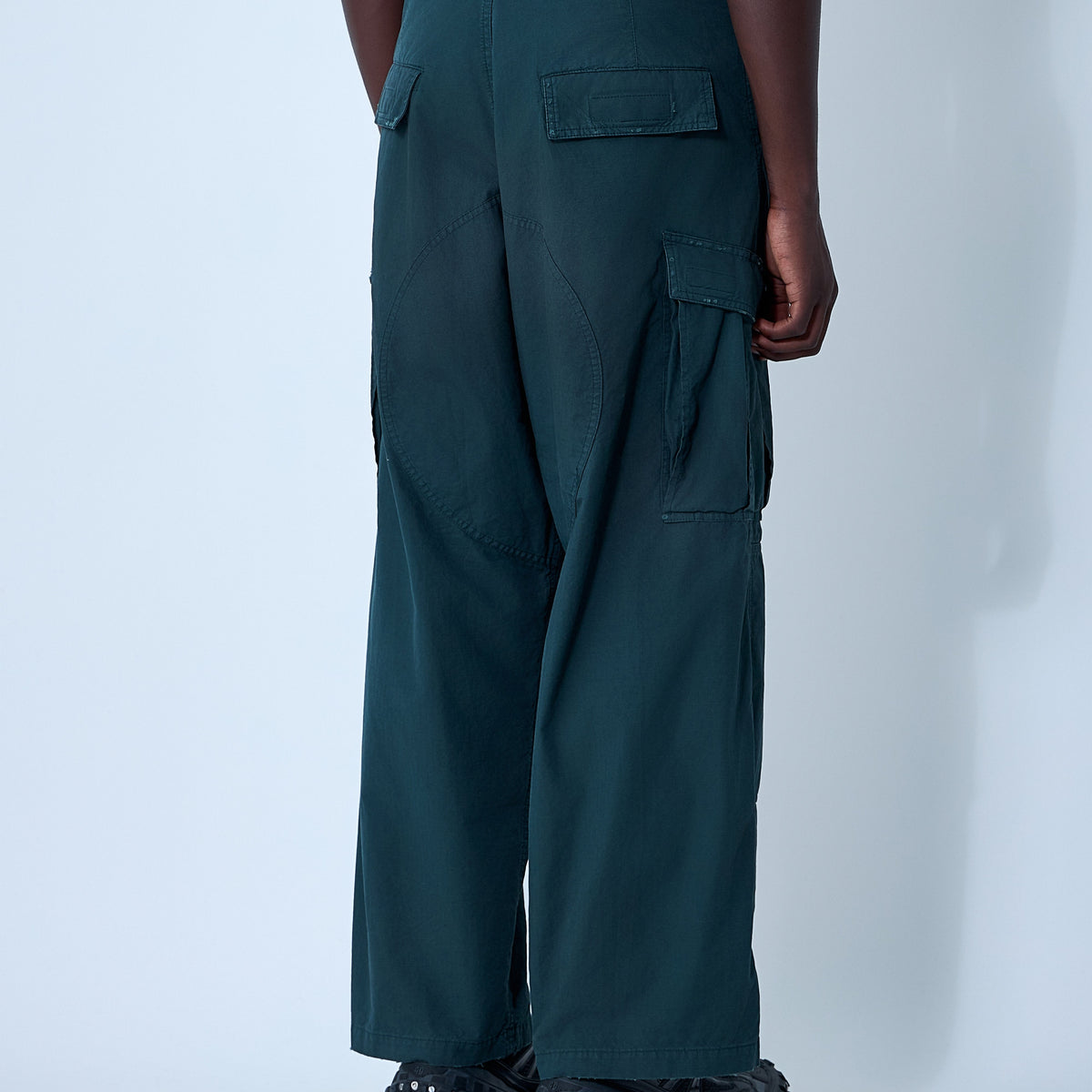 Close-up of Balenciaga pants hardware and fine stitching