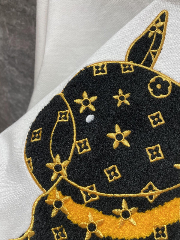 Flat lay presentation of Louis Vuitton luxury clothing with label-forward styling