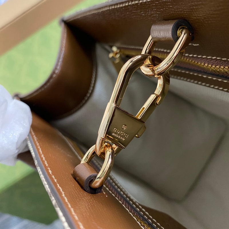 Styled lifestyle shot of signature polished women's handbag – women's designer-style accessory