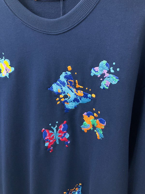 Full styled look of Louis Vuitton luxury clothing with label-forward styling