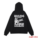 Flat lay presentation of Rhude luxury clothing with signature branding