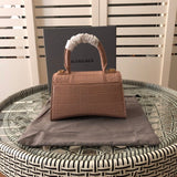 Handle and strap detail of polished elevated women's handbag – women's luxury accessory