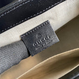 Side profile of polished classic women's handbag – women's statement bag
