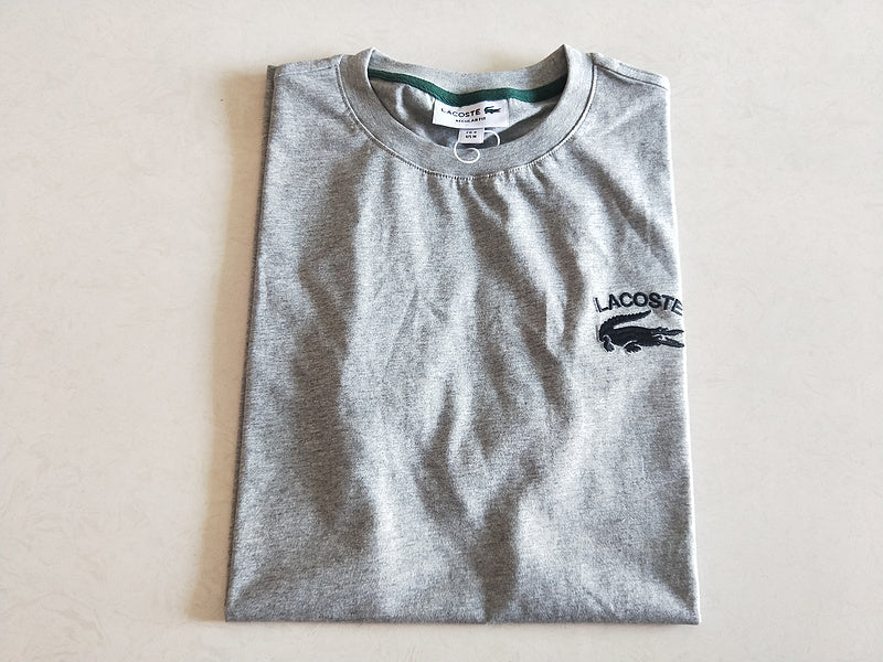 Flat lay presentation of Lacoste luxury clothing with signature branding