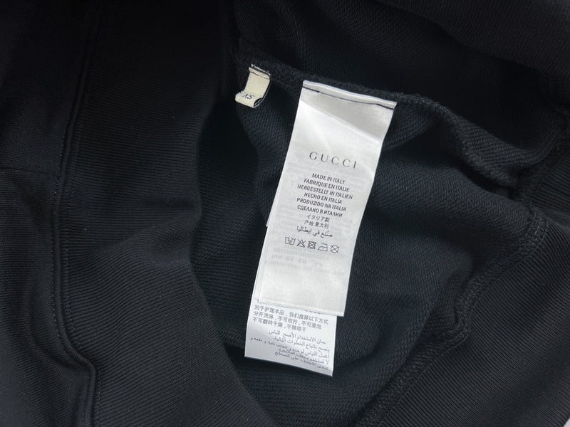 Side profile of Gucci luxury clothing with signature branding