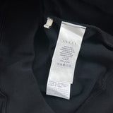 Side profile of Gucci luxury clothing with signature branding