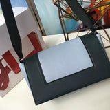 Styled lifestyle shot of classic signature women's handbag – women's luxury handbag