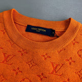 Flat lay presentation of Louis Vuitton luxury clothing with monogram-inspired silhouette