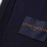 Flat lay presentation of Louis Vuitton luxury clothing with label-forward styling